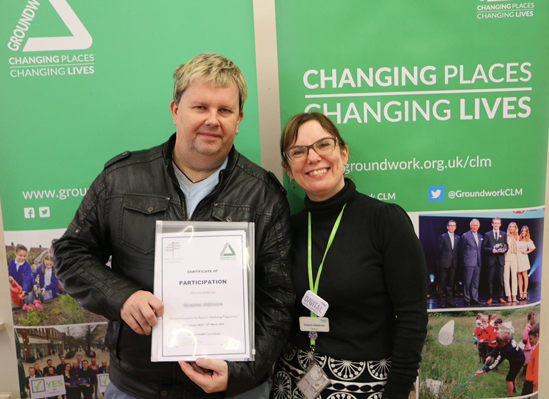 Roots To Wellbeing participant receives completion certificate