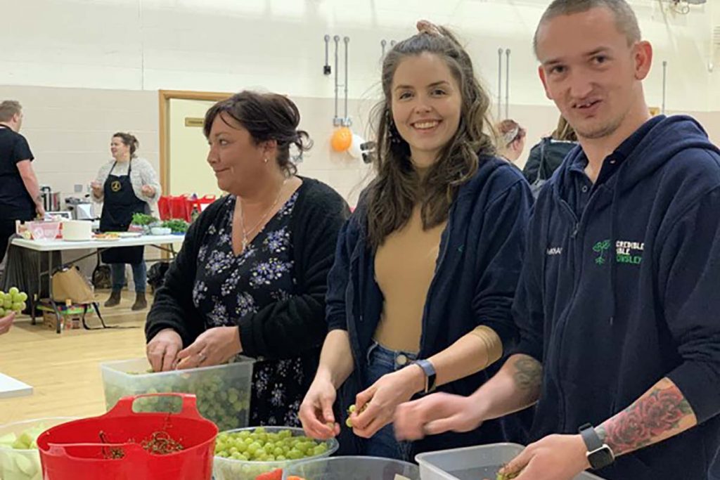 Lea preparing food at an event.