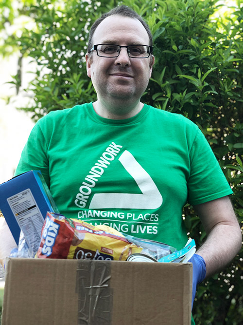 Groundwork employee with food parcel