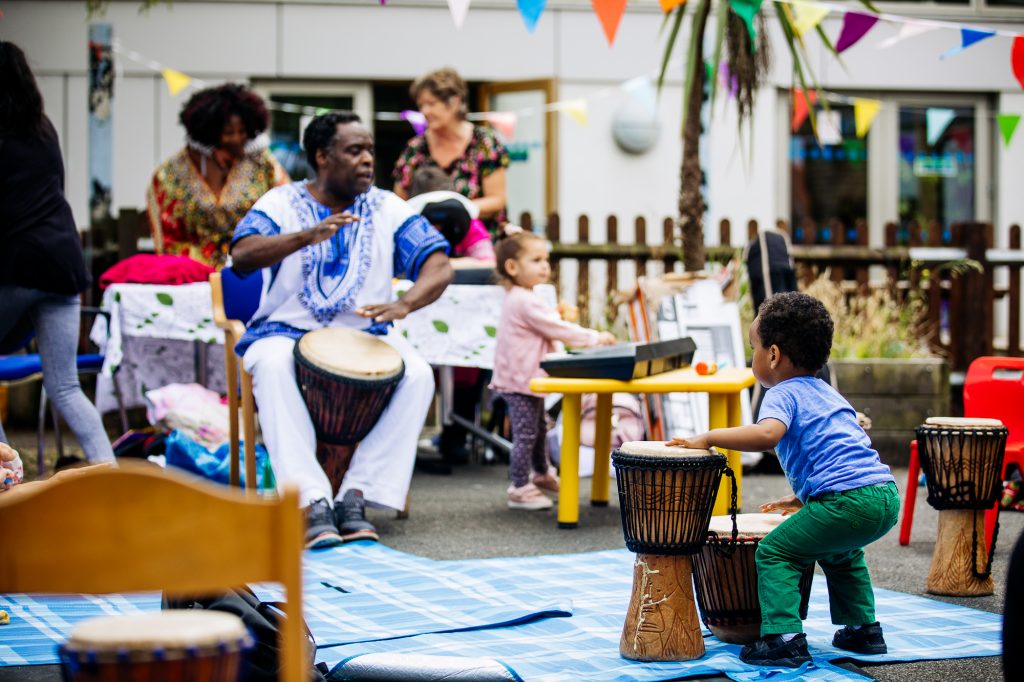 toddler playing drums at LEAP awardee's rhythm session