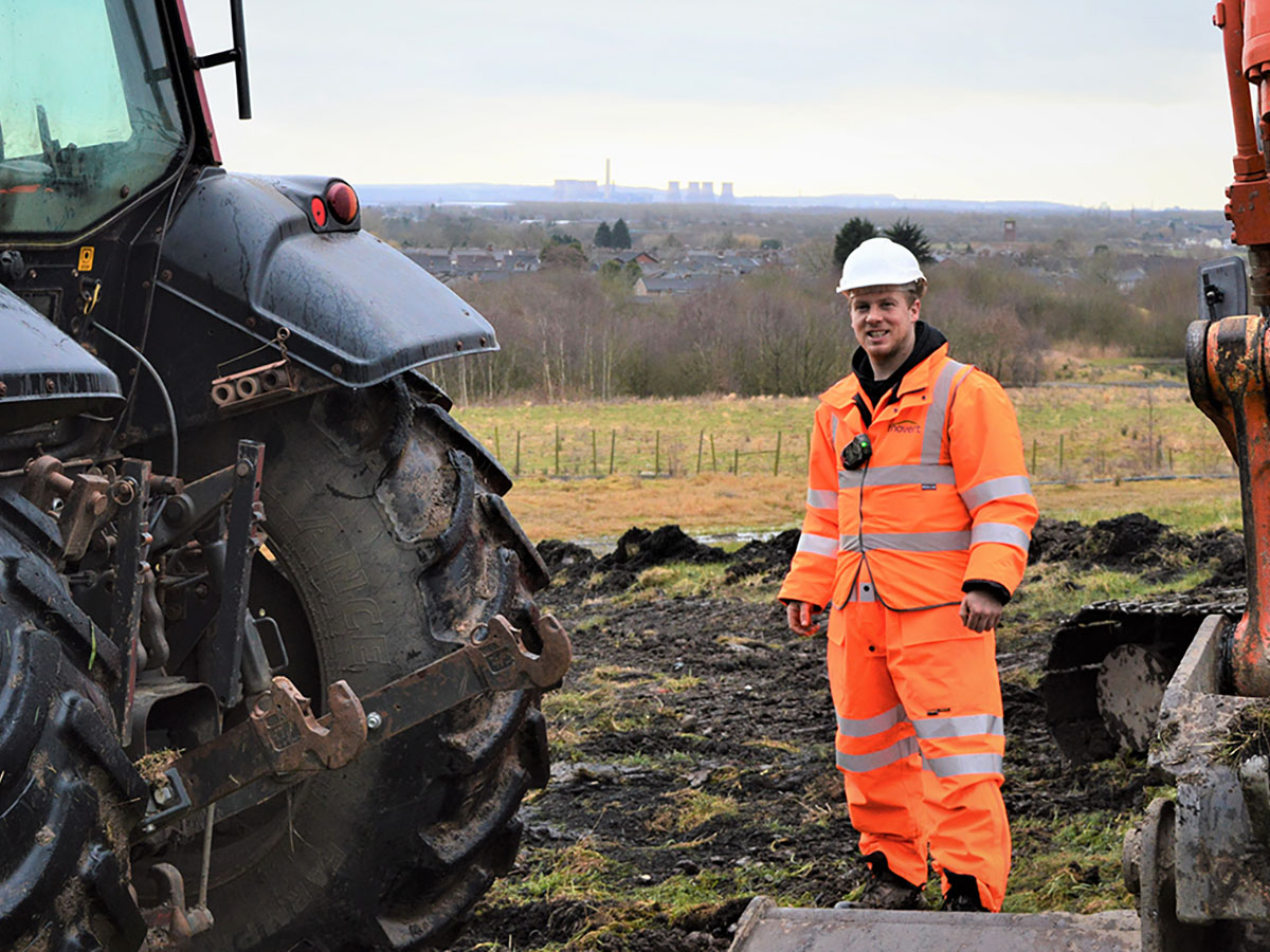 Scott working outdoors with tractors