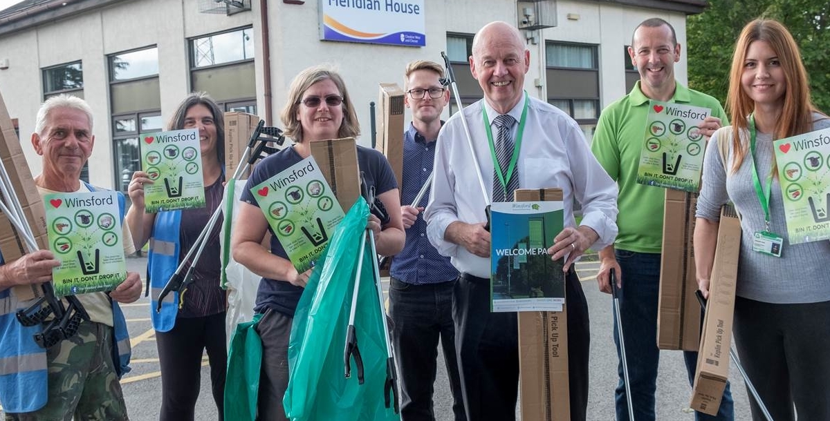 Group of people picking up litter