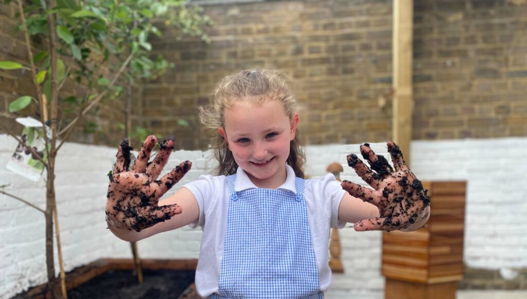 School girl planting a garden