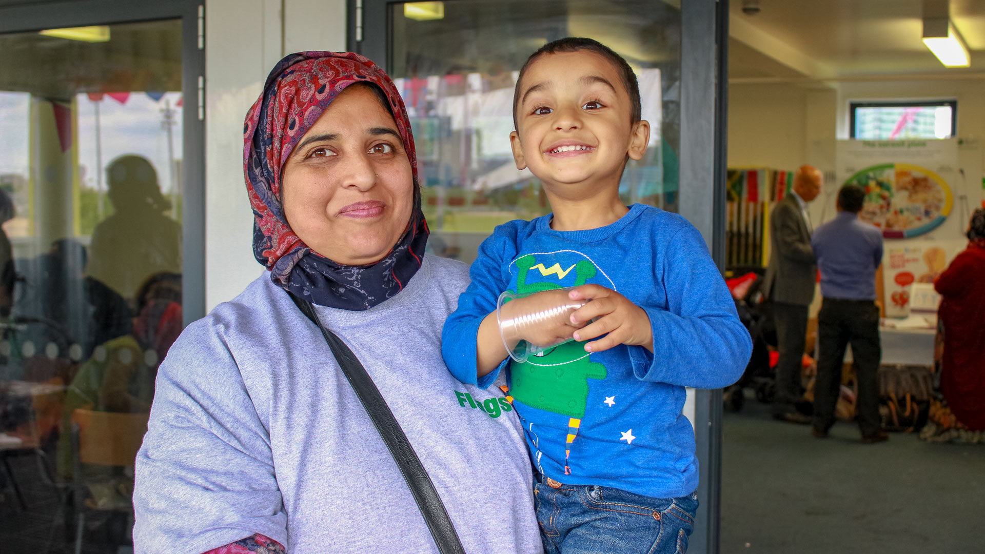 Migrant mother and child smiling