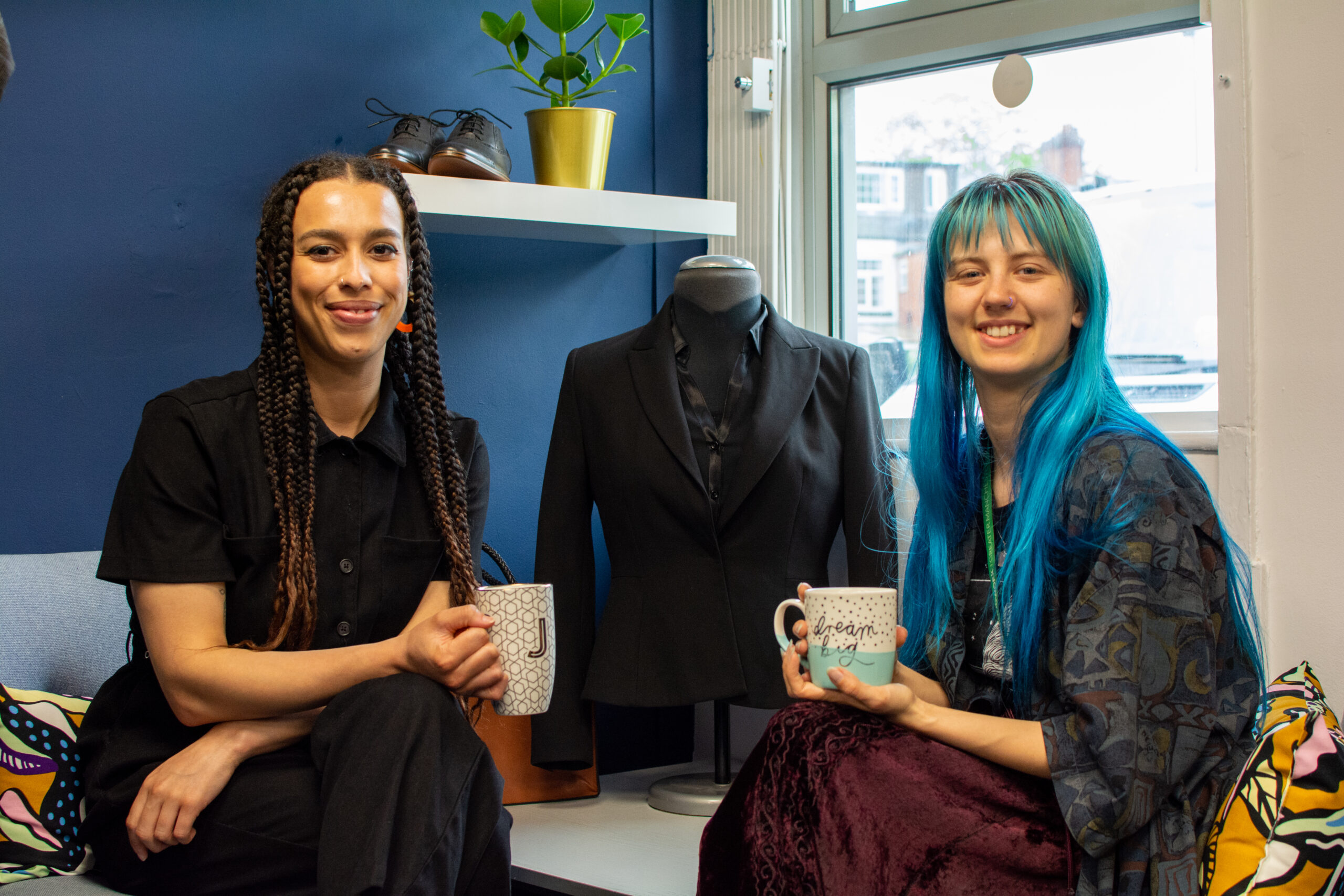Working Wardrobe staff smiling with mugs of tea