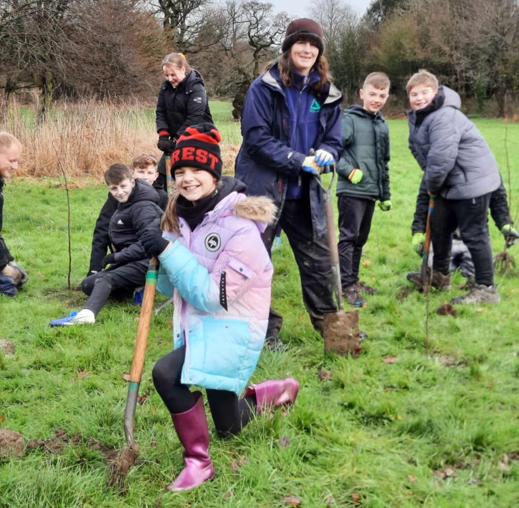 Groundwork volunteer with children getting involved with volunteer work
