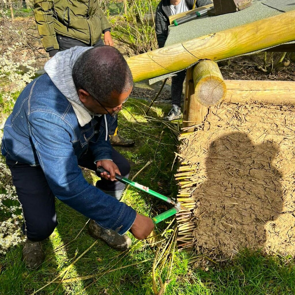 VOLUNTEERS BUILDING A HUT
