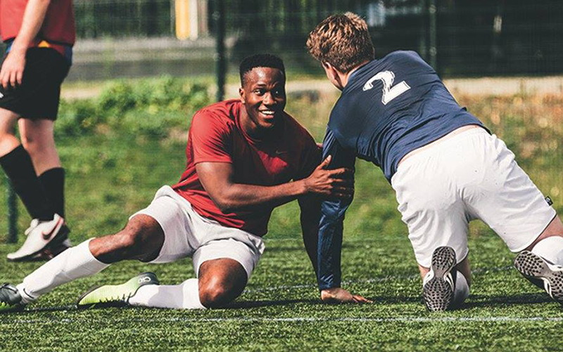 Two football players in red and blue tops