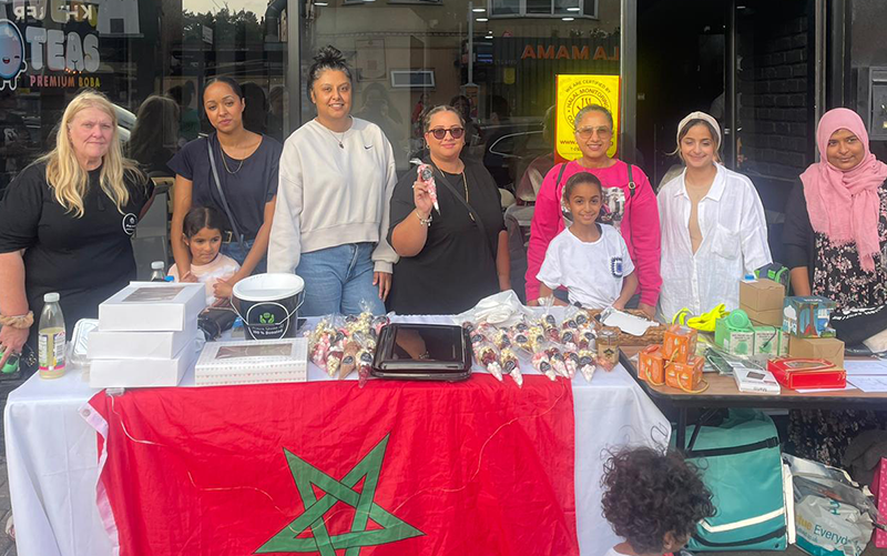 Group of people with items on table and Moroccon flag