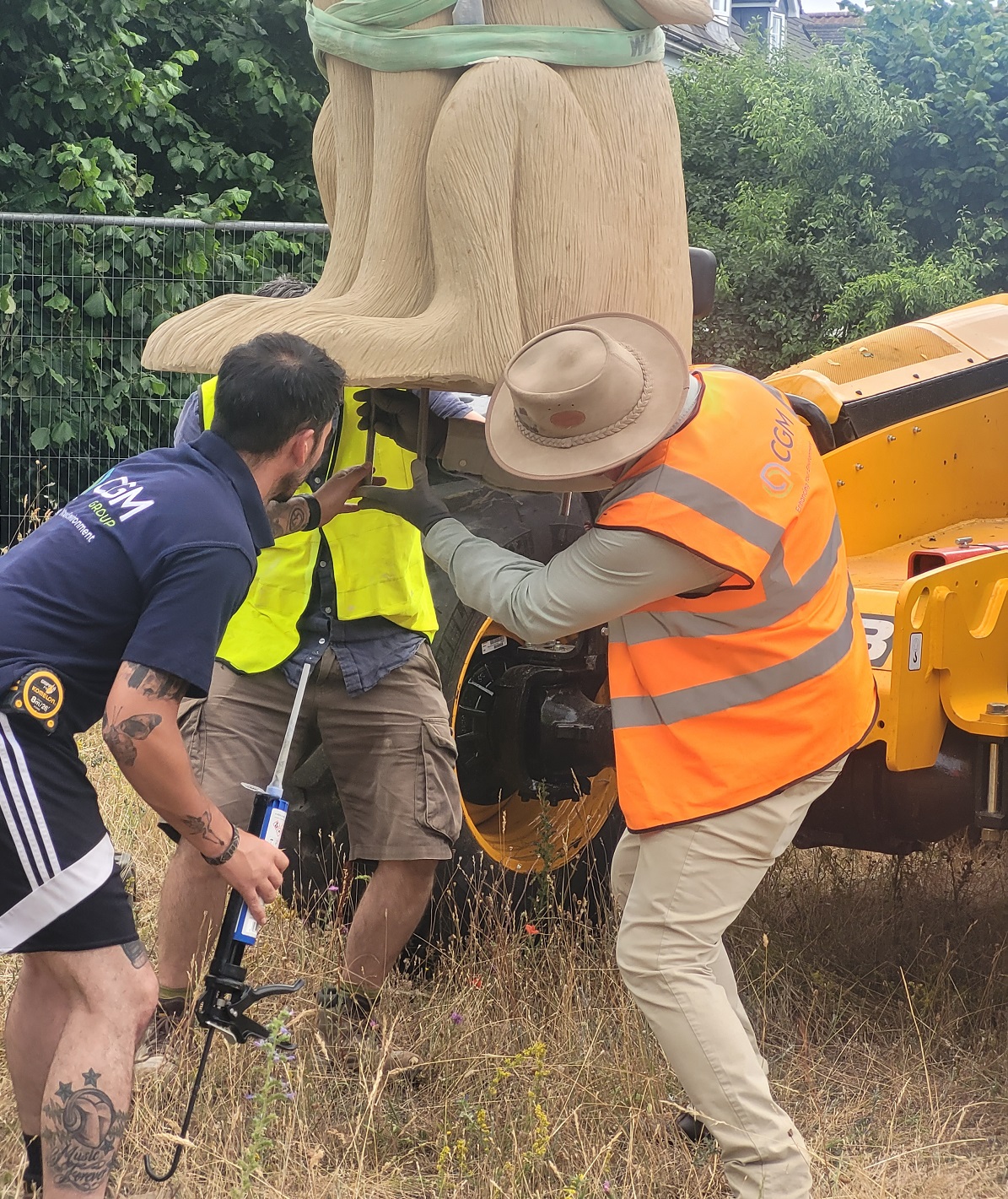 Giant stone sculpture being craned onto site