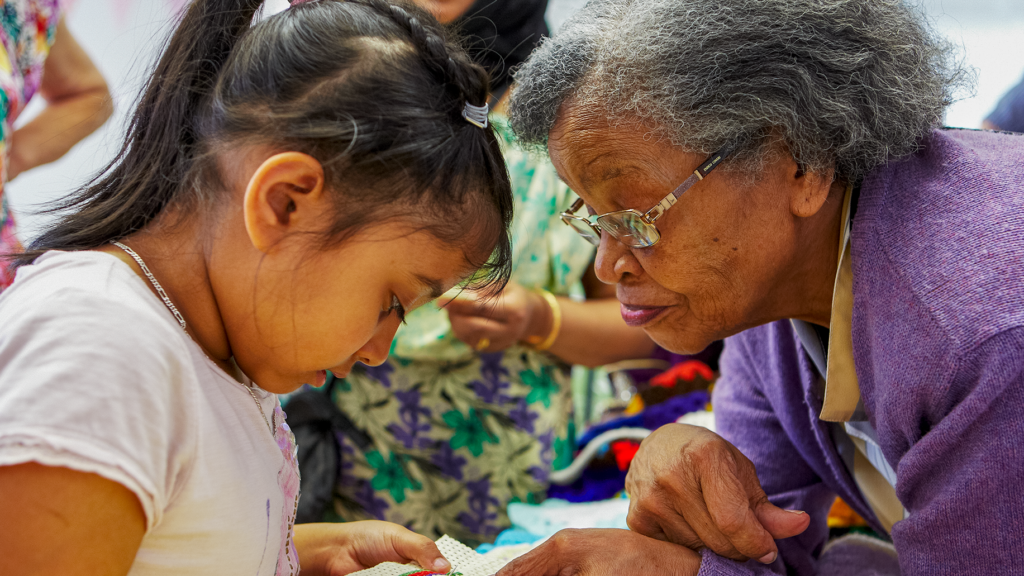 Child and pensioner involved in an activity at a community event