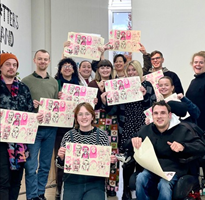 Young people holding up posters