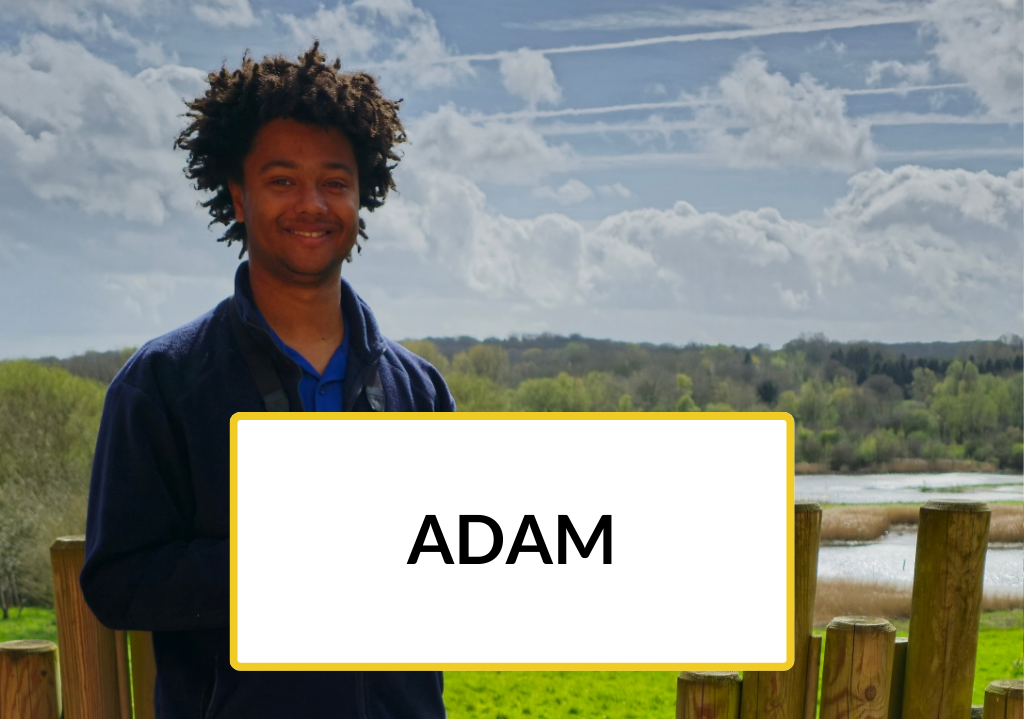 Adam, a New to Nature Trainee, smiling outdoors.