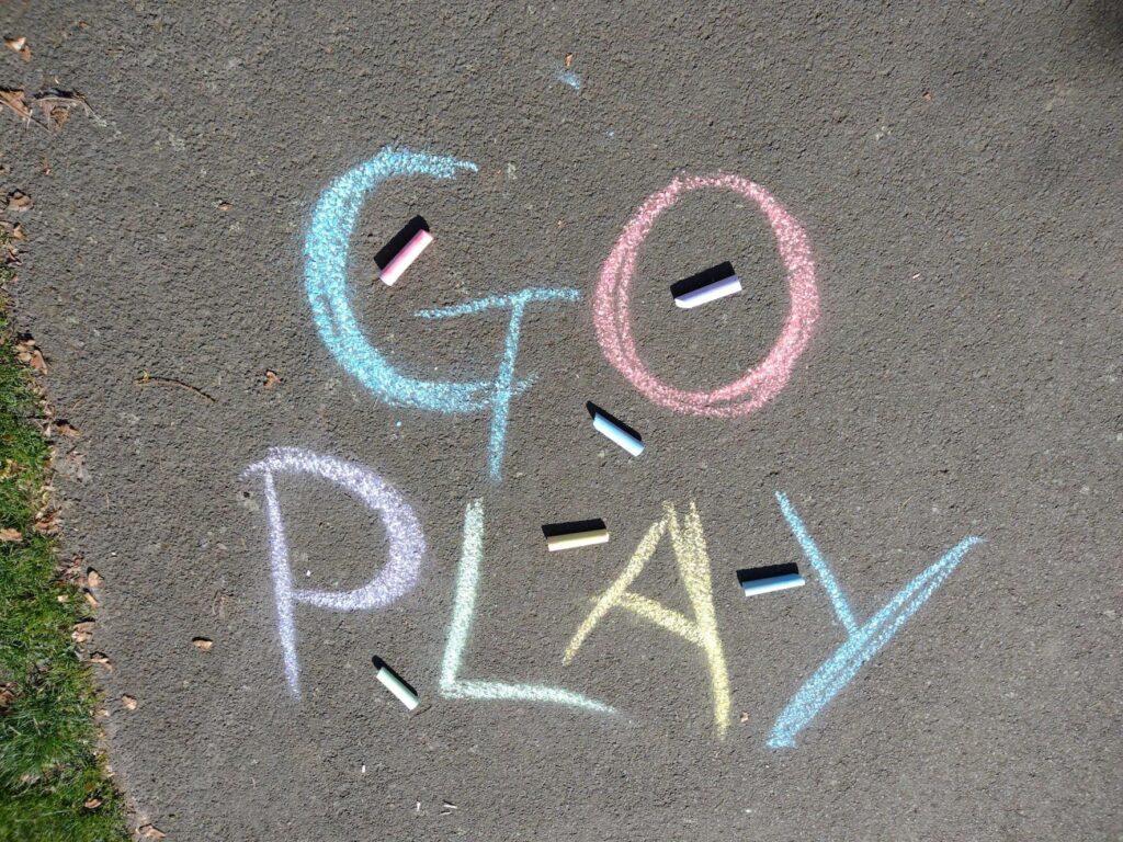 Go Play written in chalk