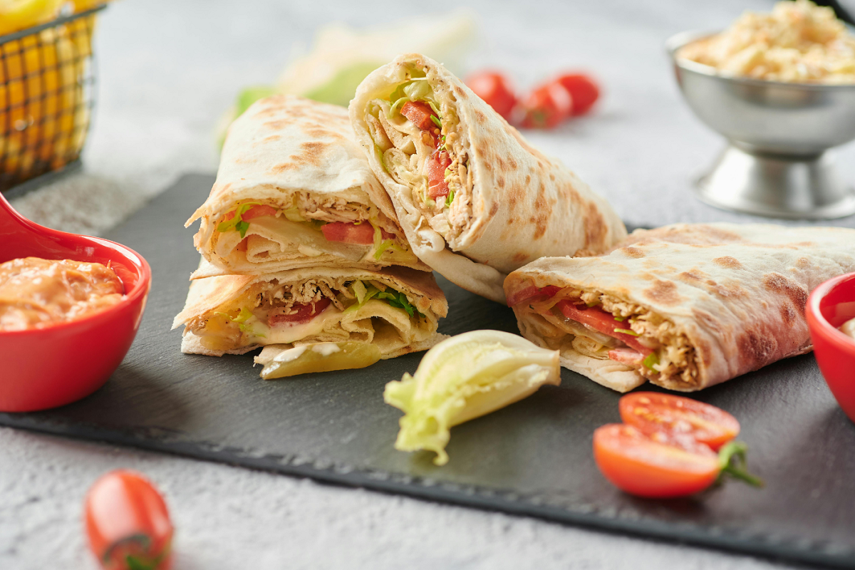 Salad and cheese wraps on a table