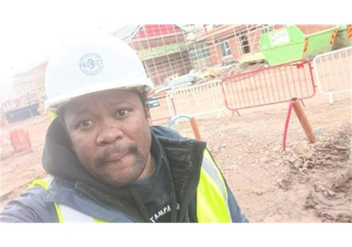 Lee on a construction site after receiving employment and skills support