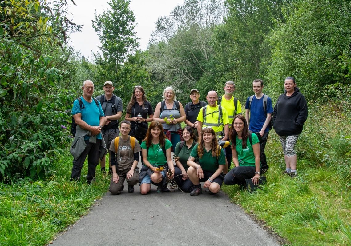 Josh posing for a photo with volunteers and staff