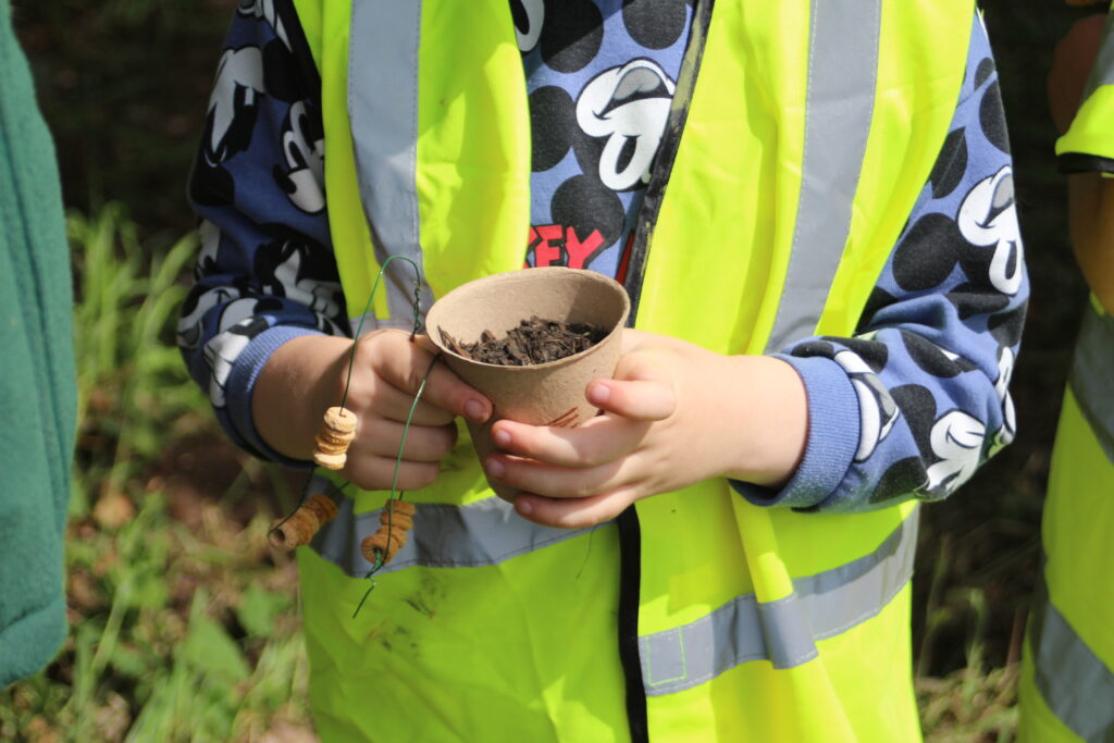 A child holding a plant pot