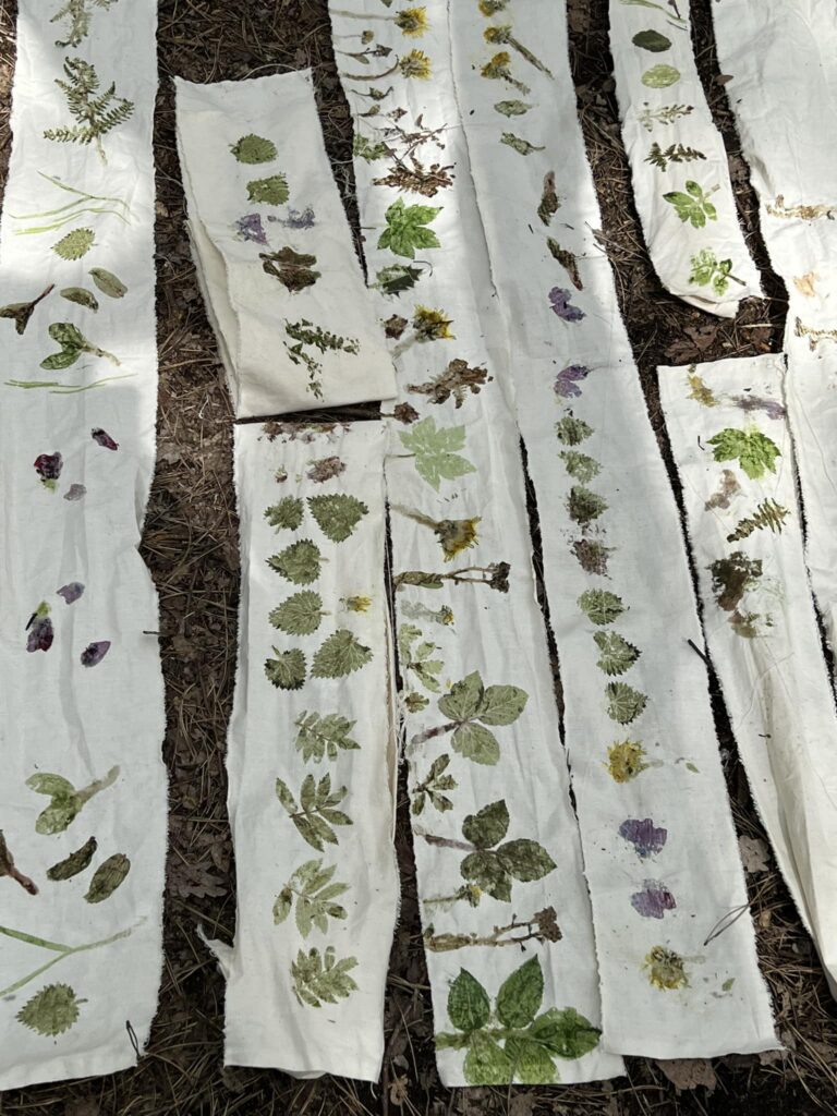 Strips of white fabric with leaves and flowers imprinted.