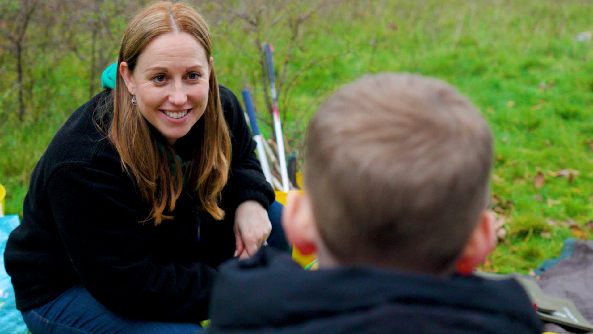 Photo of Hannah, smiling at a child