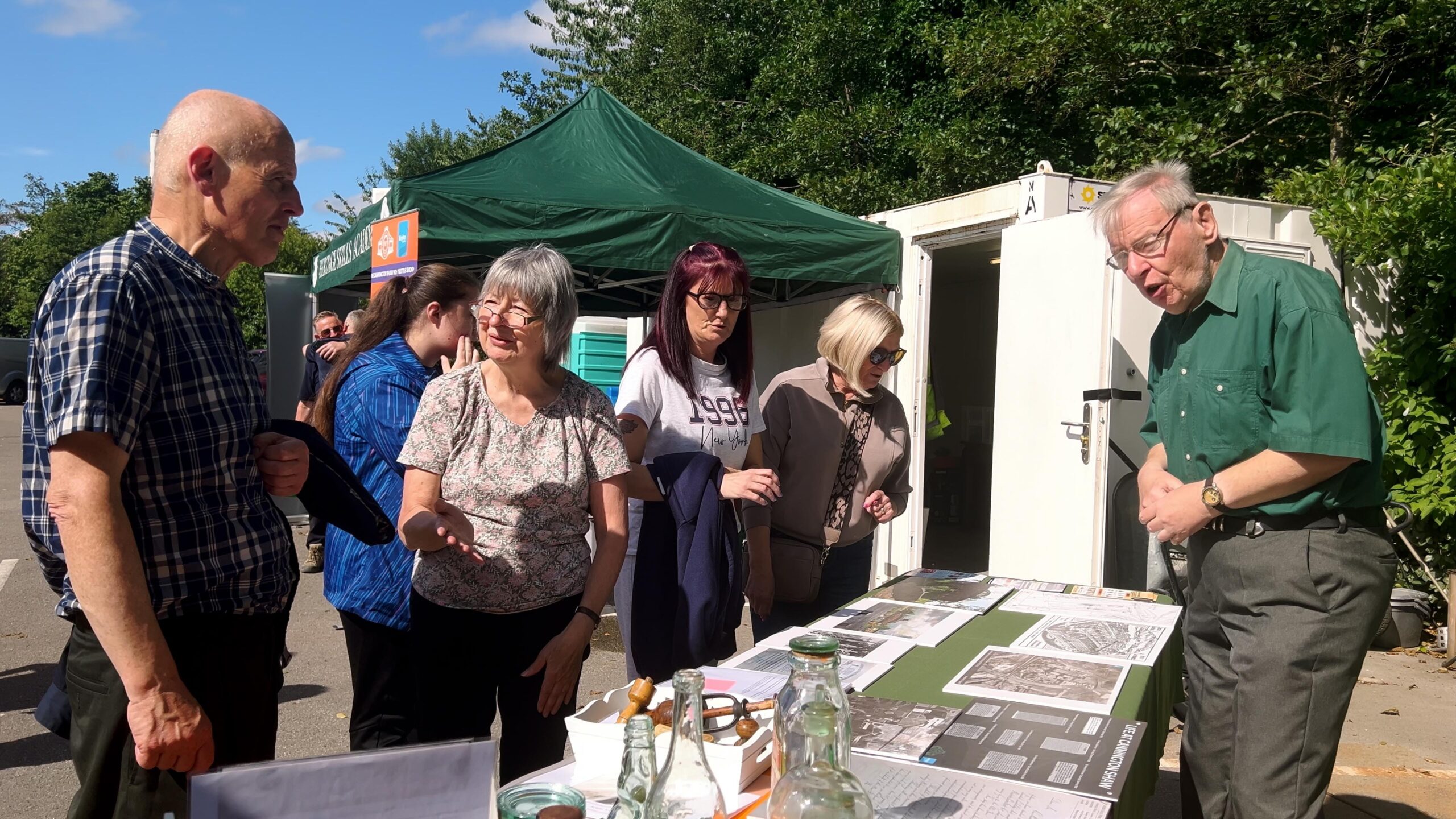 Visitors at stall learning about St Helens glass making history and heritage.