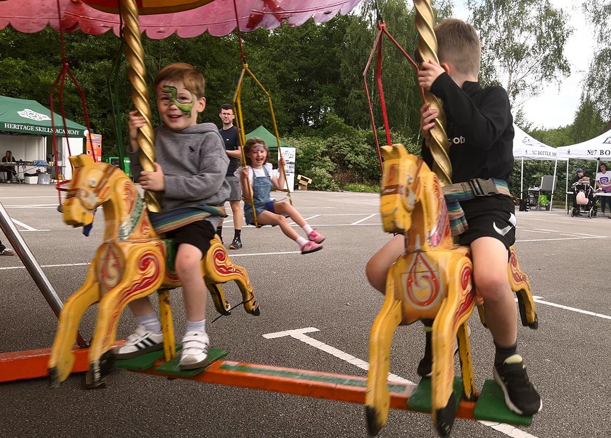 Young children riding carousel.
