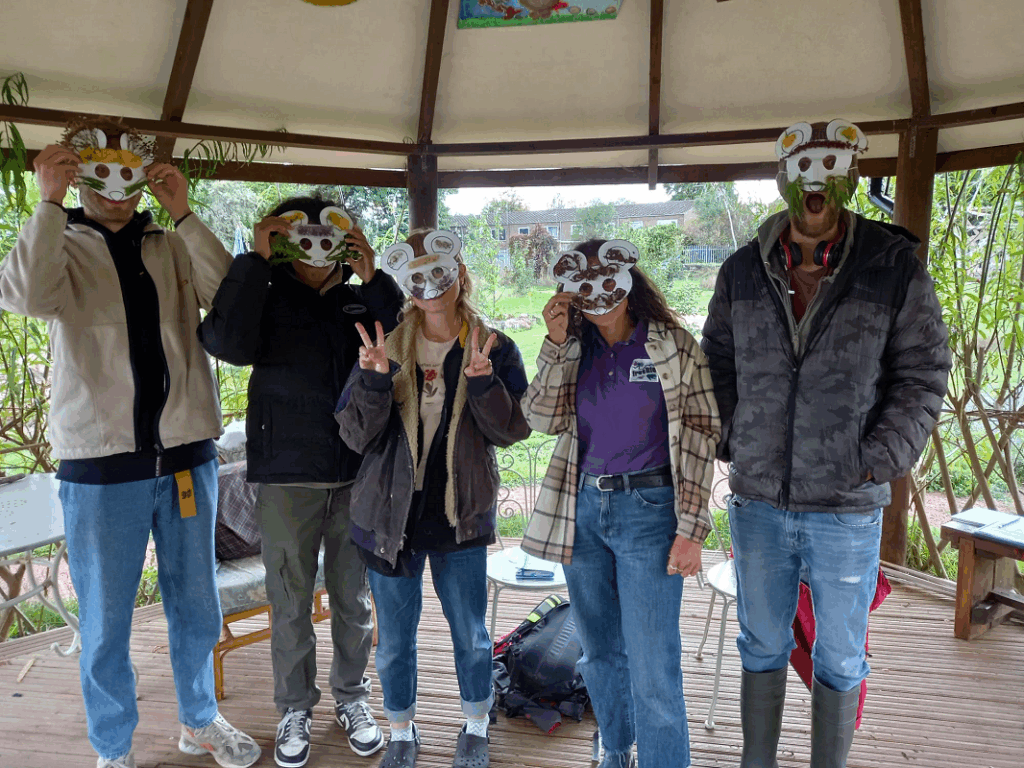 Adults in homemade masks undertaking the wellie sin the woods training