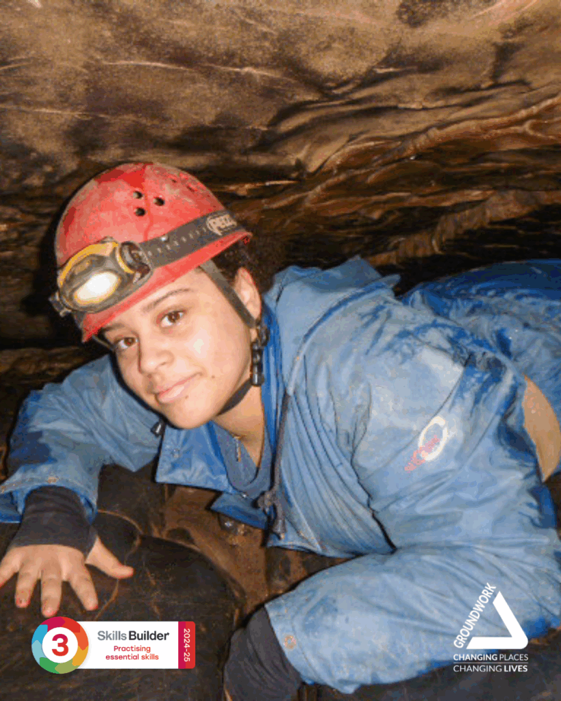 Young person doing caving in Wales while at the Youth Leadership Programme's residential by Groundwork London