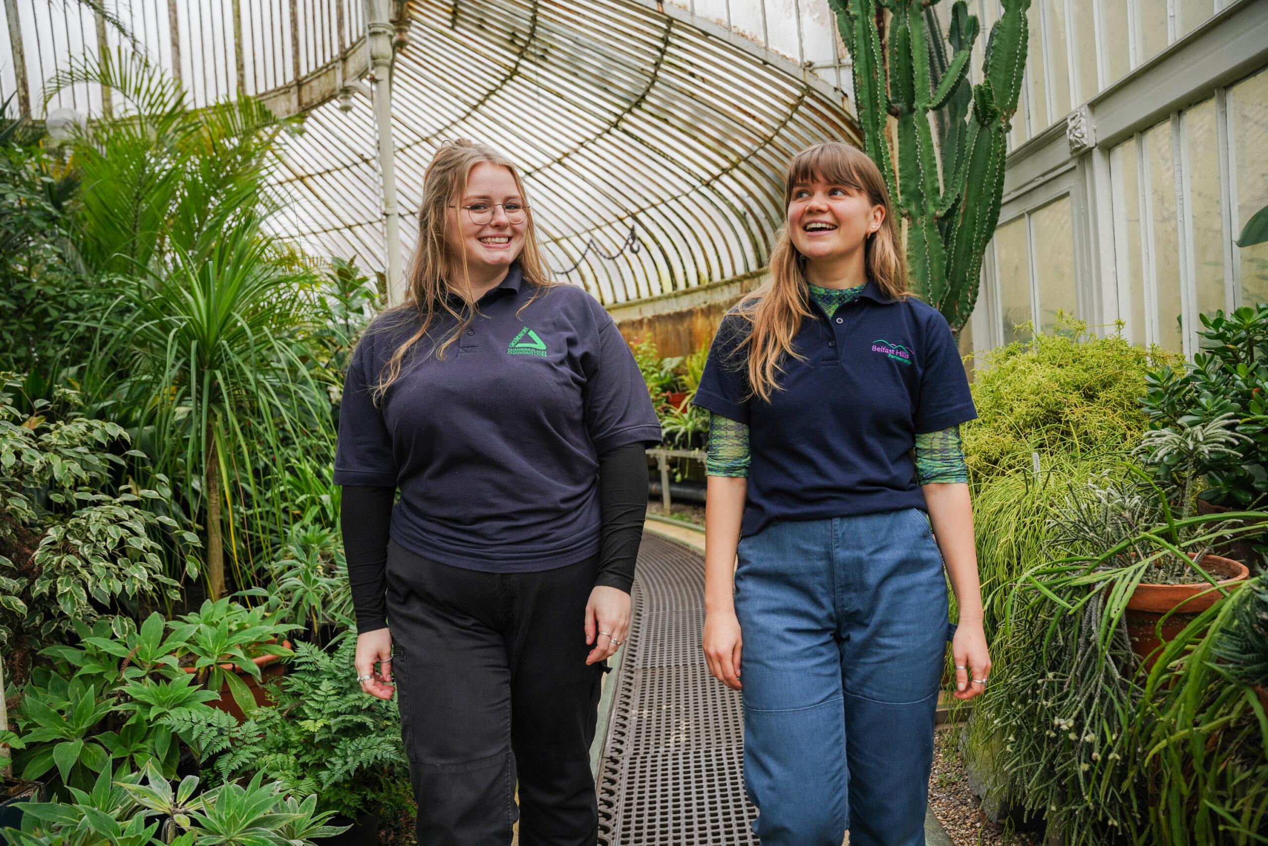Photo of two young women walking in an indoor garden centre