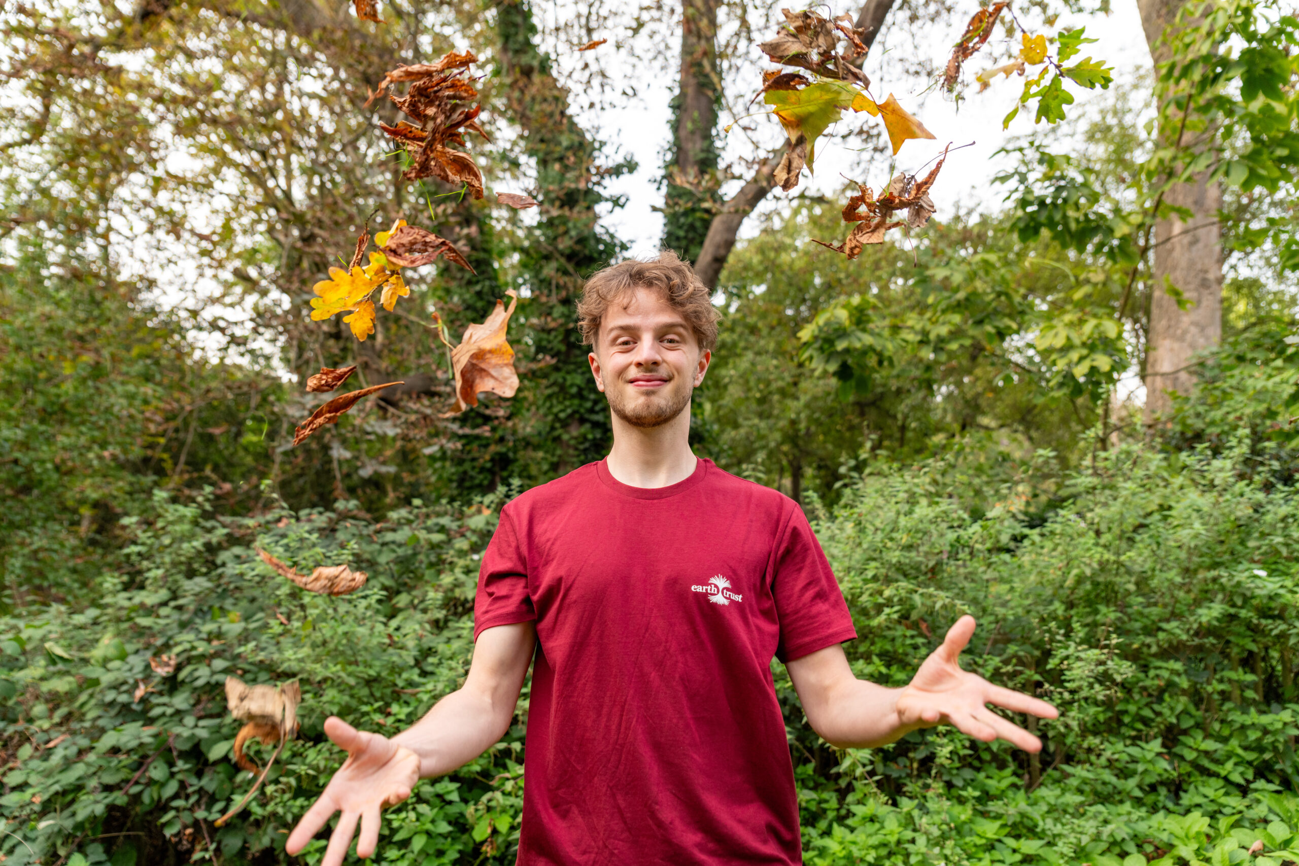 New to Nature Trainee throwing leaves up