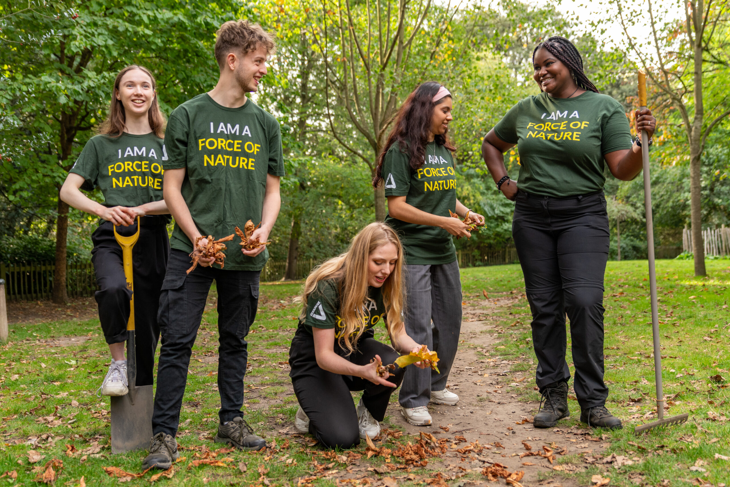 Photo of New to Nature trainees outside with gardening equipment