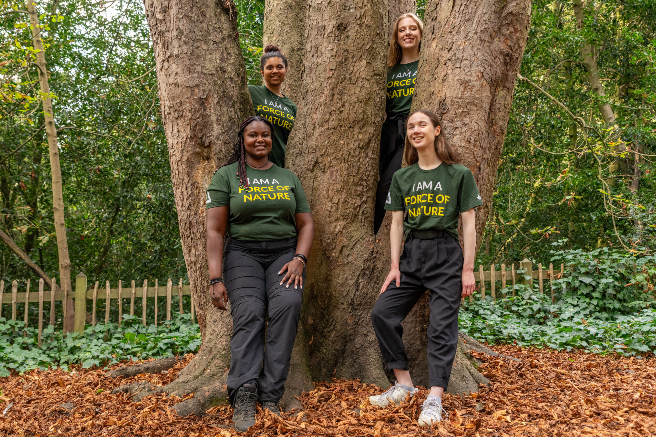 New to Nature Trainees standing in between a large tree