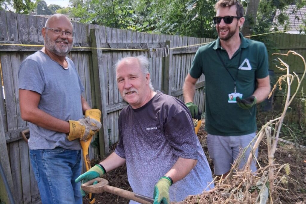 People clearing a garden space