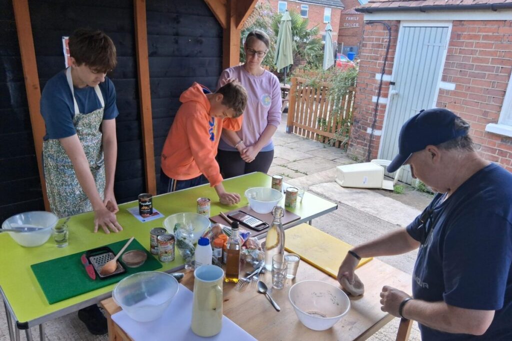 Group of adults cooking outside together