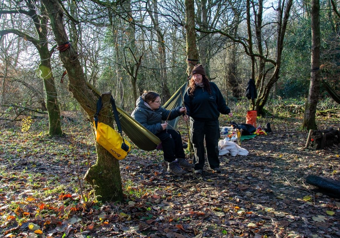 Lucy doing nature crafts in a hammock