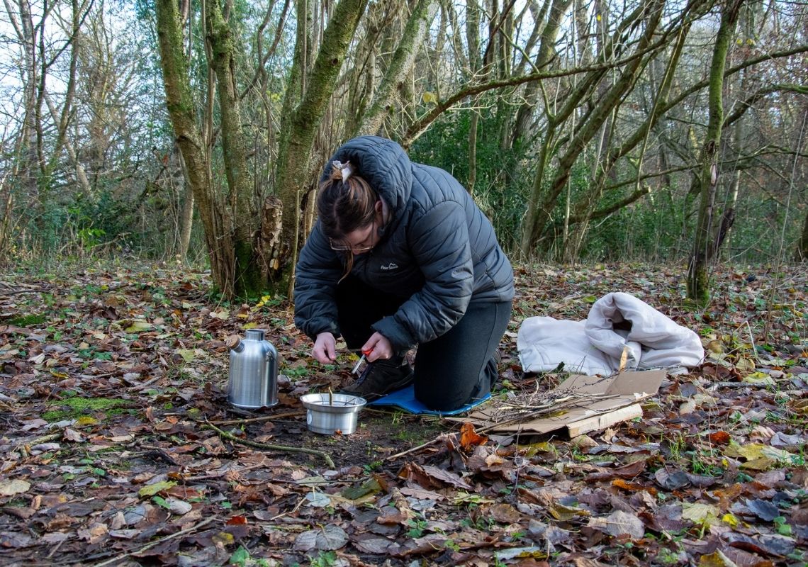 Lucy taking part in outdoor learning using a kelly kettle