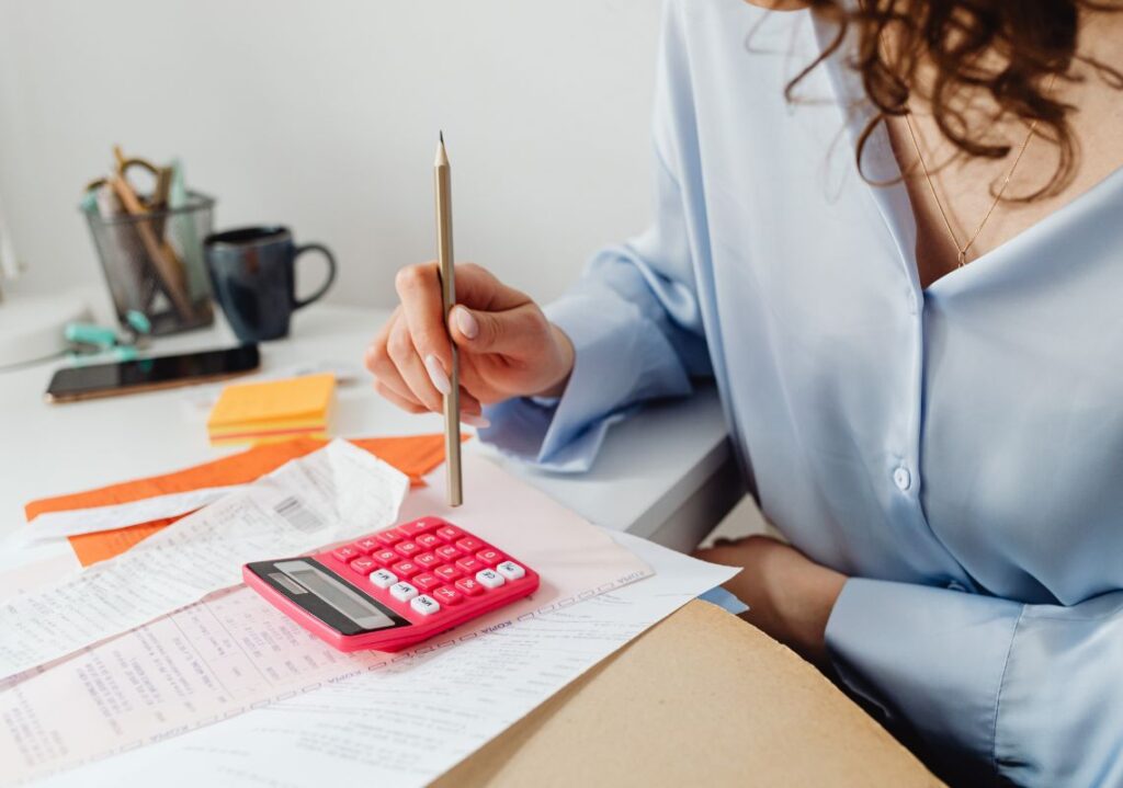 Woman with calculator and receipts