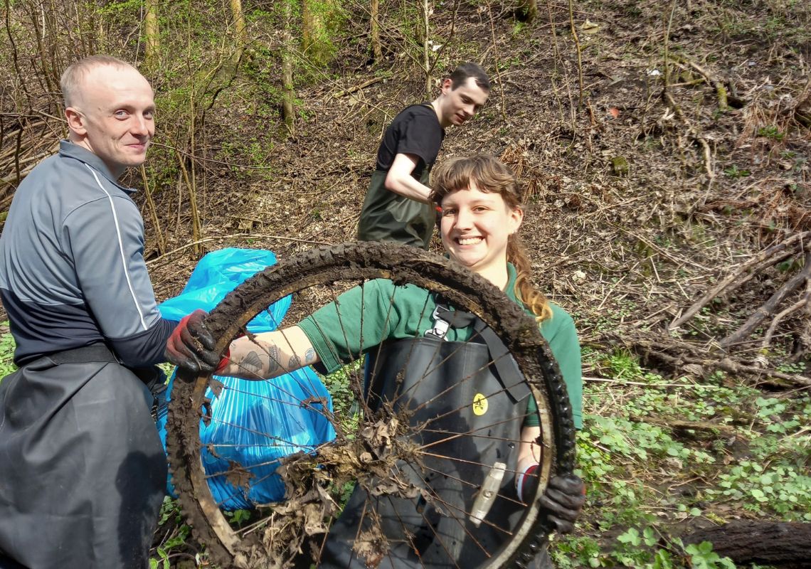 Travis clearing litter with other volunteers