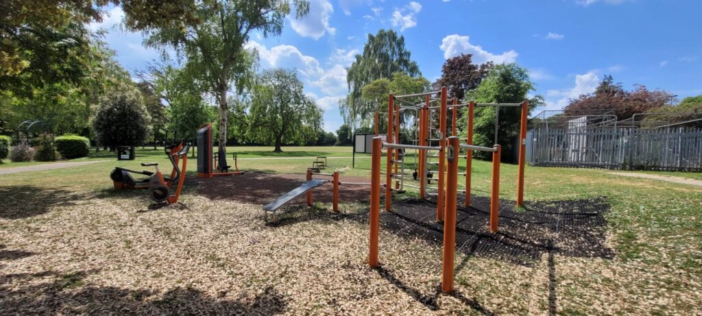 A playground with climbing apparatus in the foreground