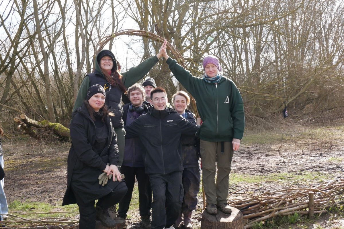 Group of people together smiling outside