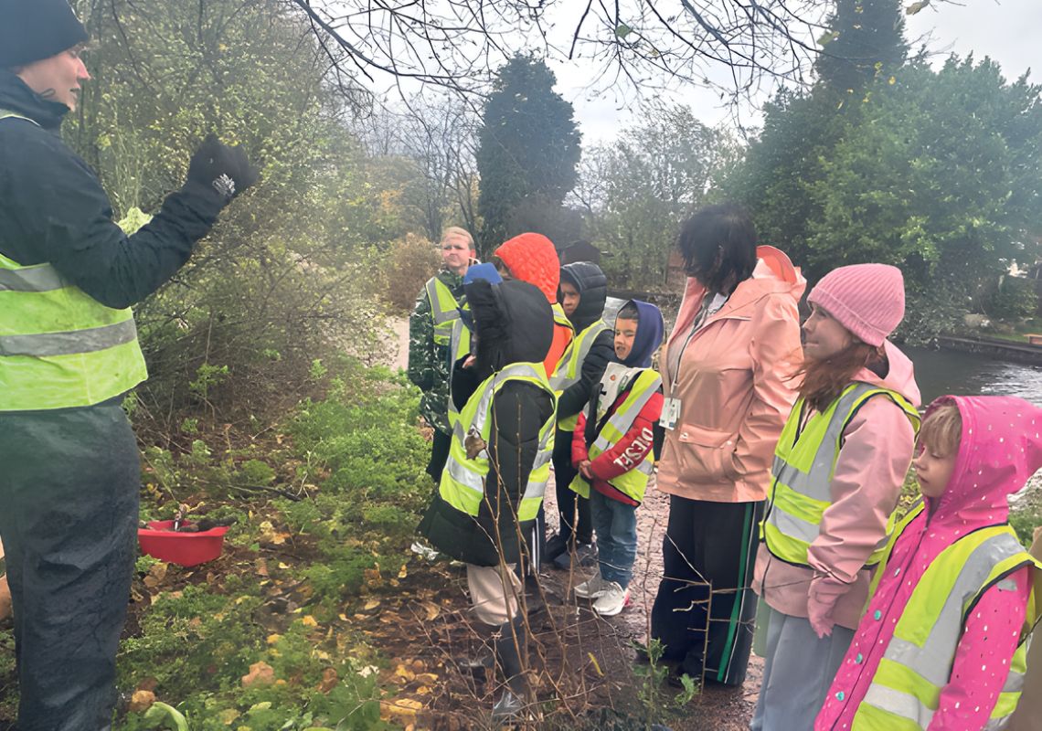 Young people planting near the canal