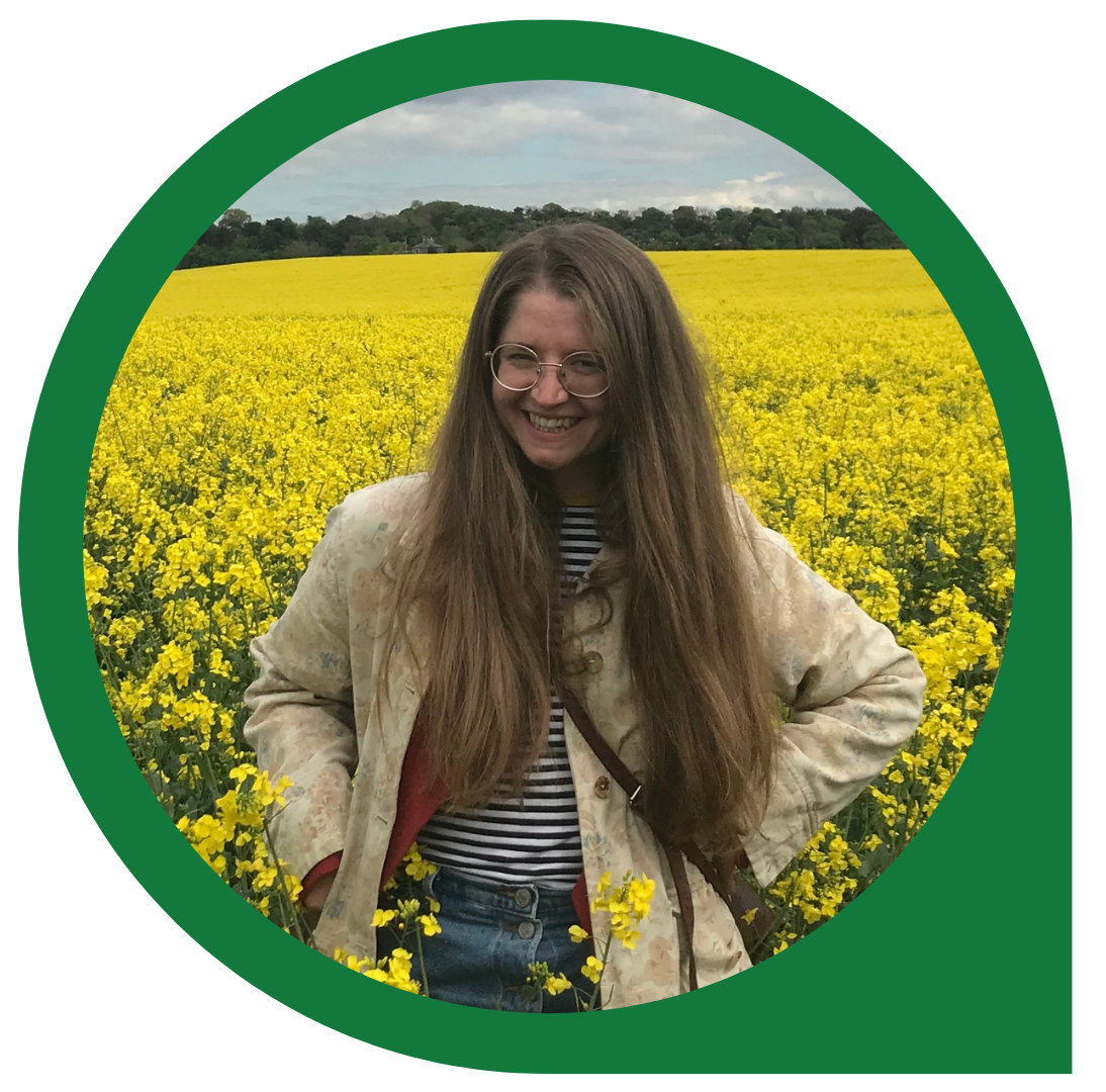 Female in a bright yellow field smiling