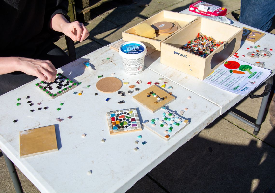 Creating mosaic tiles at a Tameside alleyway