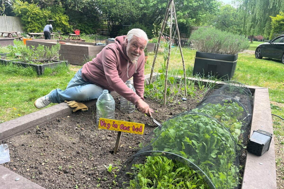 Particpant digging in a raised bed