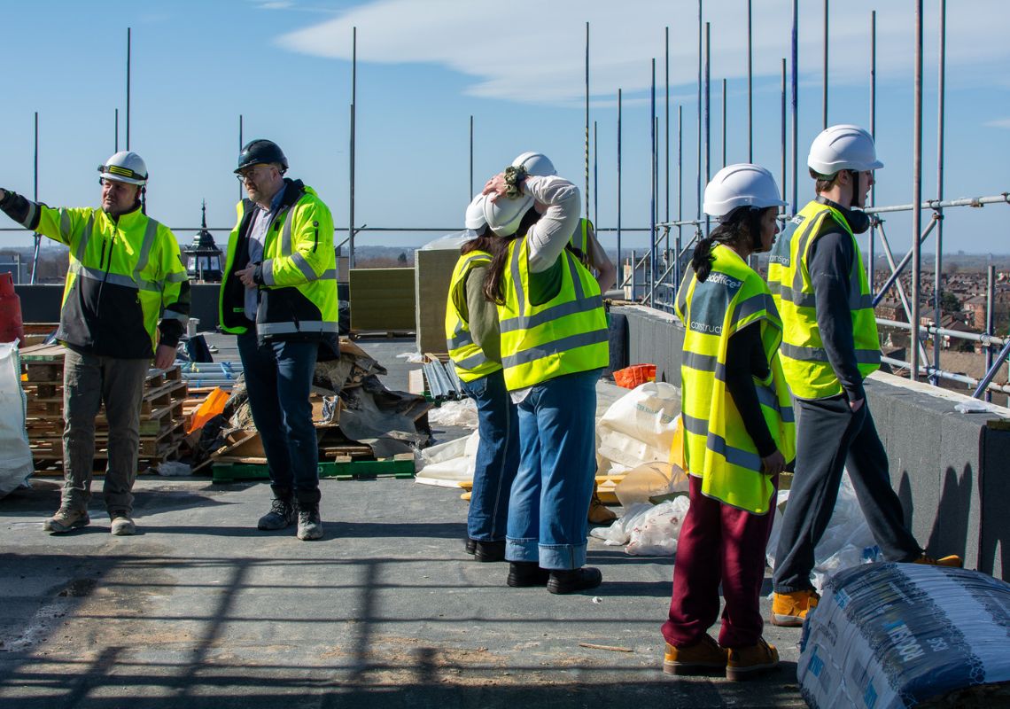 Adela and other participants on a construction site
