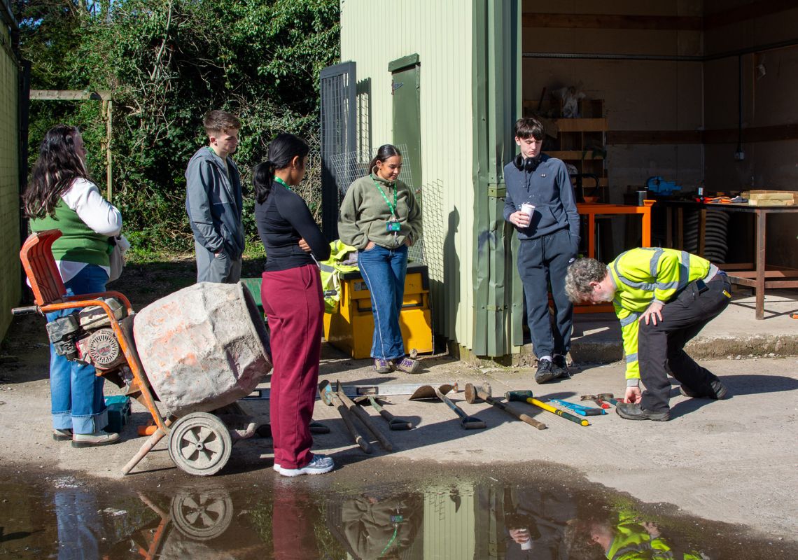 Adela and other participants receiving tools training on their work placement