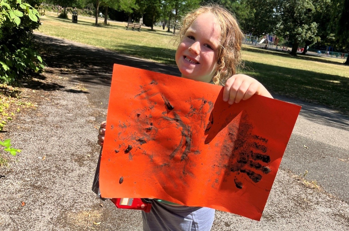 Smiling child showing off their picture