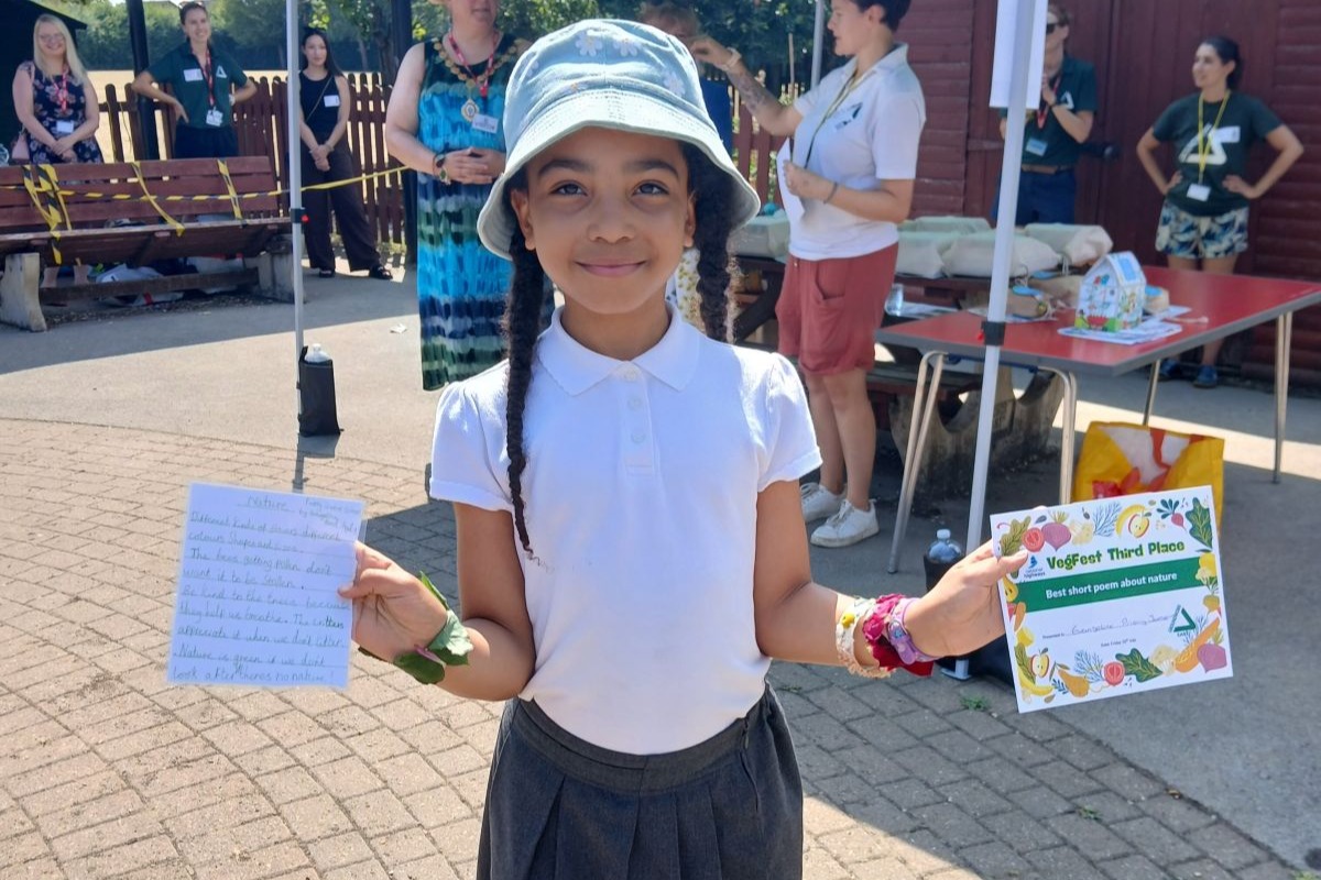 Pupil showing off her certificates