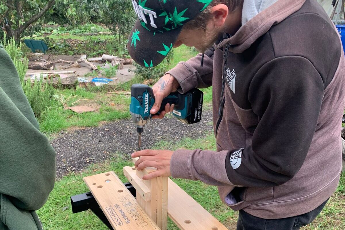Green Sparks participant drilling into wood
