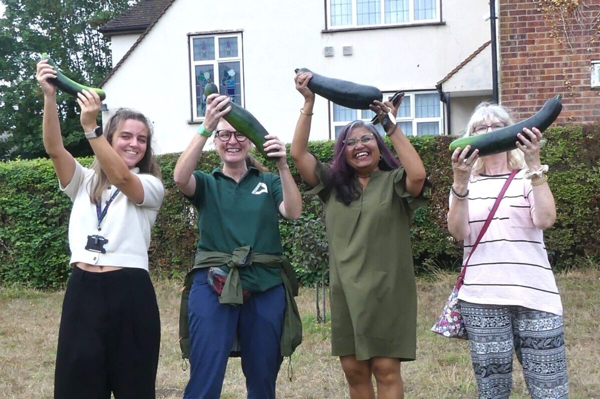 Members of Quaker House holding marrows